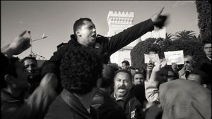 Tunis, Tunisia (2011). Watershed. A policeman who just joined the demonstrators leads the crowd to besiege Government House.