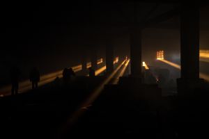 An abandoned warehouse where sleeping around 1,500 refugees. The rays of the sun break through