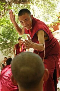 Sera Monastery is outside of Lhasa, Tibet. It is known for the dramatic debates held every day in a grove of trees. A common sight is one monk standing and, in a dramatic flourish that includes loud clapping of the hands, challenging the beliefs of a second, sitting monk. Photographed on 29 June 2005. © Forest McMullin