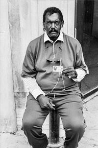 A licensed beggar downtown offers his city-issued permit.