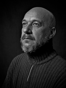 Portrait of a man with a turtleneck sweater.