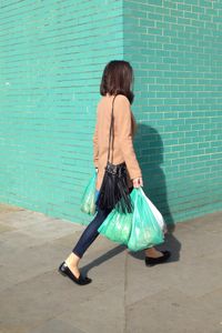 Green brick wall and shopping bags.